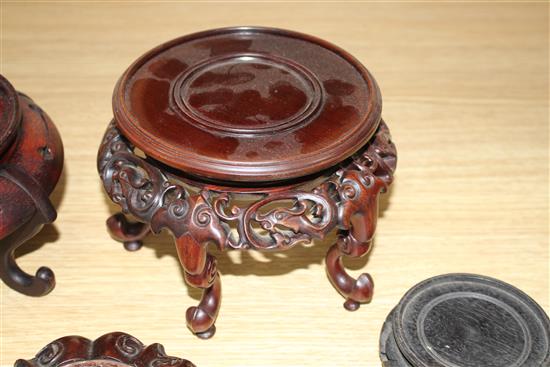Thirteen assorted mainly Chinese hardwood vase stands, largest diameter 17cm, height 12cm